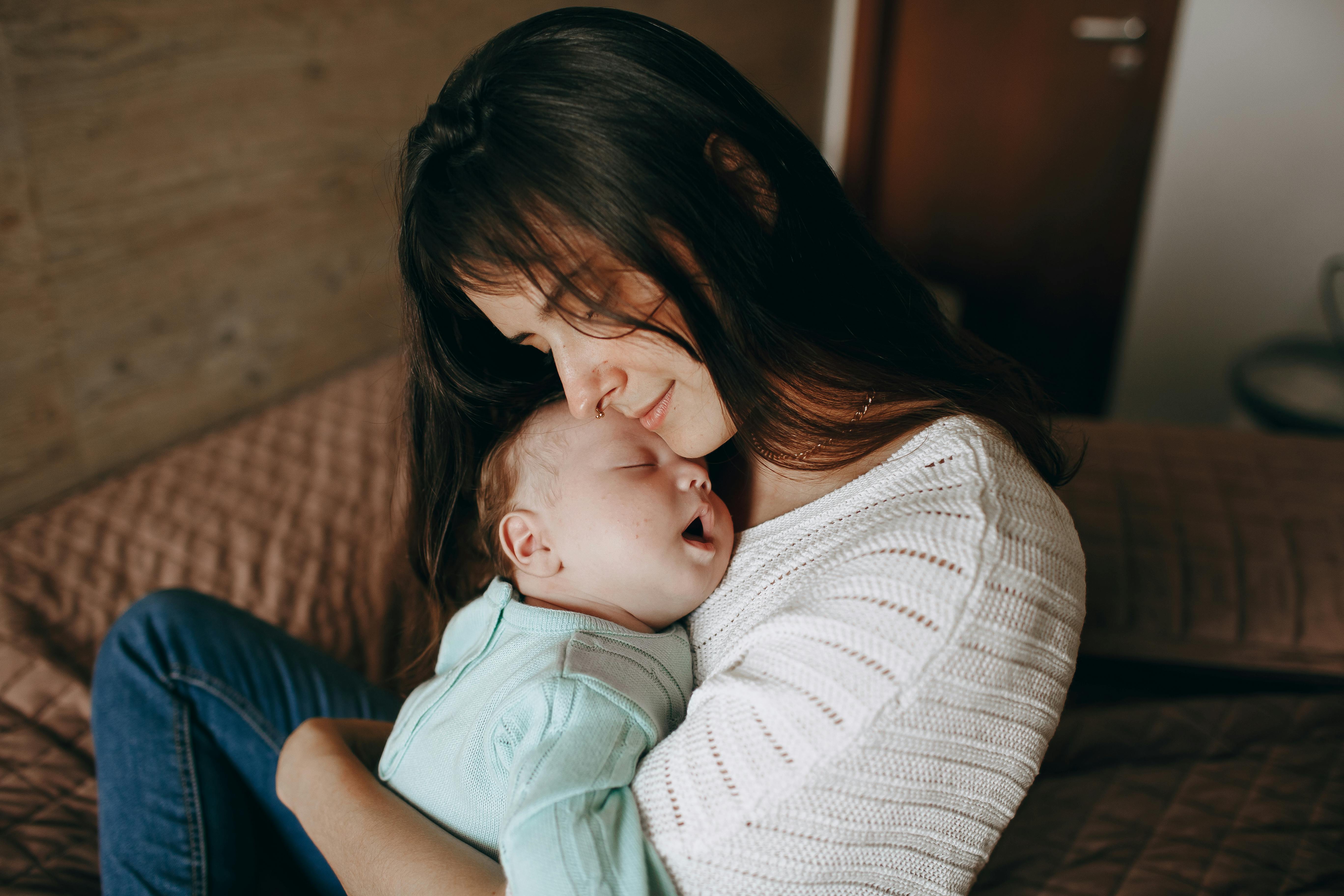 Mother tenderly holding her newborn